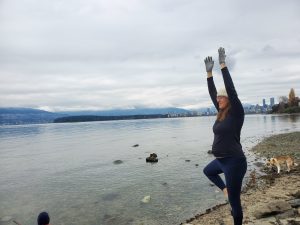 Diana Mello practices her tree pose at the beach.